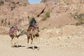 Petra, Jordan Ã¢â¬â December 25th, 2015: Bedouin man riding a camel Royalty Free Stock Photo